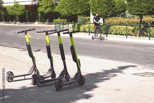 Electic scooters parked on the street, with copy space photo