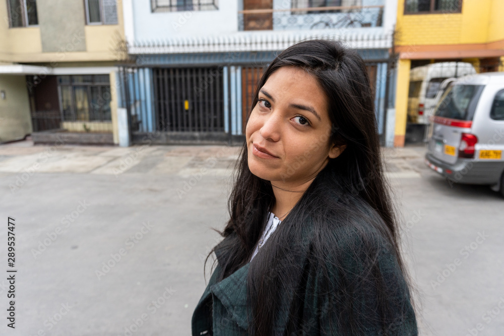portrait of young latina woman in the city