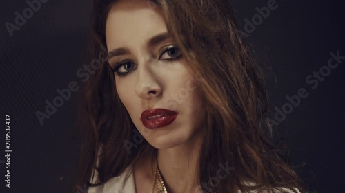 Wallpaper Mural Fashionable beautiful girl in white shirt and with gold jewelry. Gold locket. Girl look at the camera. Red lipstick. Evening make-up. Hard light and shadow on the girl’s face. Torontodigital.ca