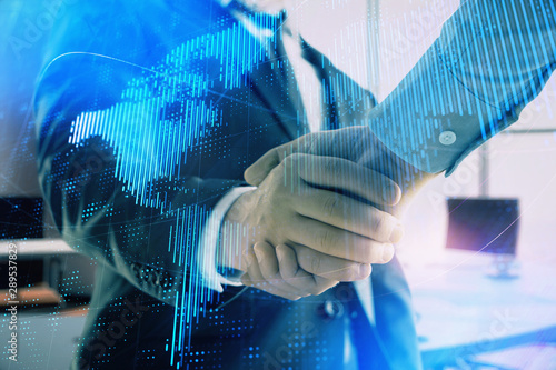 Multi exposure of world map on office background with two businessmen handshake. Concept of international business