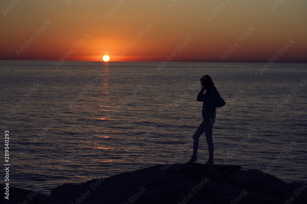 silhouette of woman at sunset