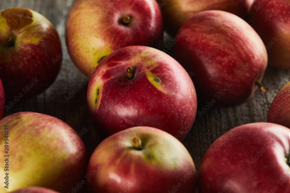 red ripe apples on brown wooden surface red ripe apples on brown wooden surface