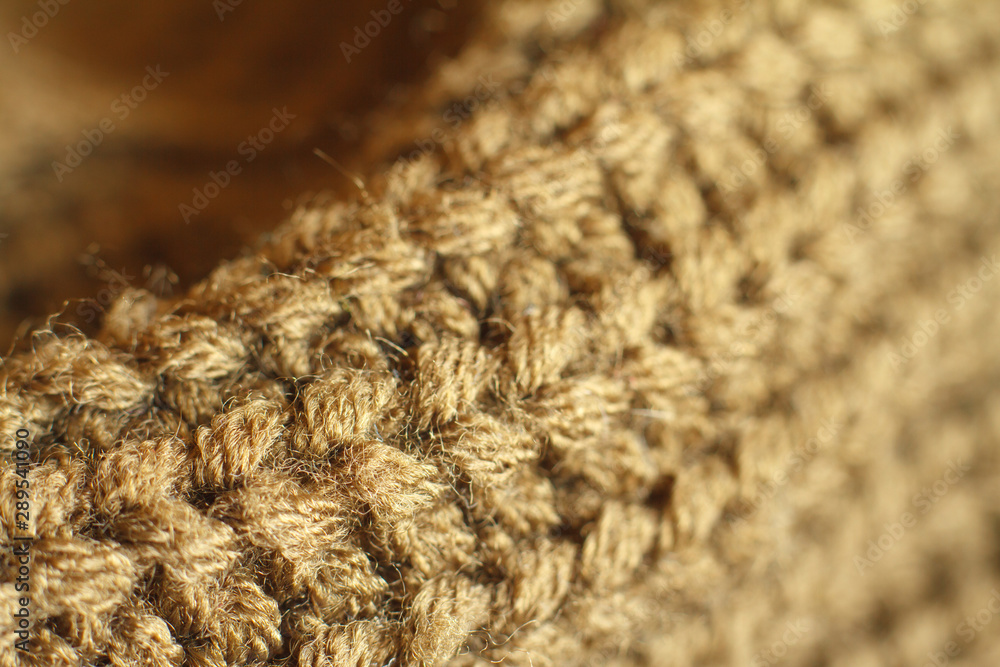 Extreme close-up ocher color knitted natural wool sweater texture, wavy folds, selective focus Extreme close-up ocher color knitted natural wool sweater texture, wavy folds, selective focus