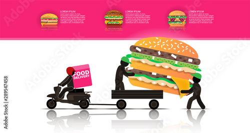 Two workers load a huge Burger into a cart