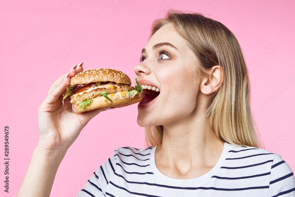 young woman eating hamburger