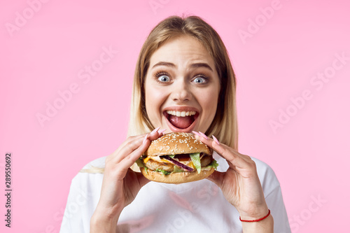 young woman with hamburger and french fries