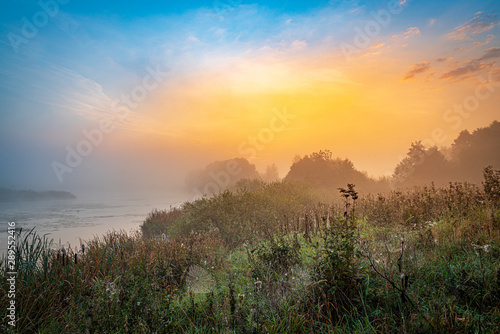 Bright golden sunrise at the riverside