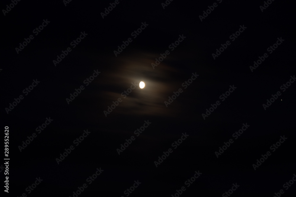 Half moon in mist and Jupiter