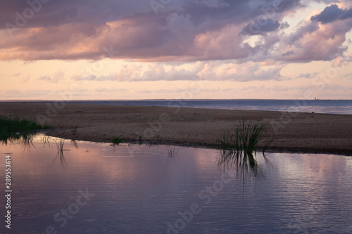 Violet-blue sunset by the sea on a summer evening