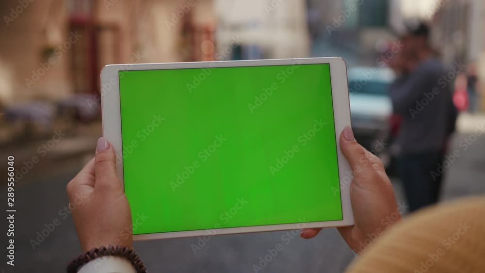 Close up hands woman using tablet device computer with green screen outdoors in street at sunlight horizontal bloom message pad technology chroma key female digital girl app chat finger slow motion Close up hands woman using tablet device computer with green screen outdoors in street at sunlight horizontal bloom message pad technology chroma key female digital girl app chat finger slow motion