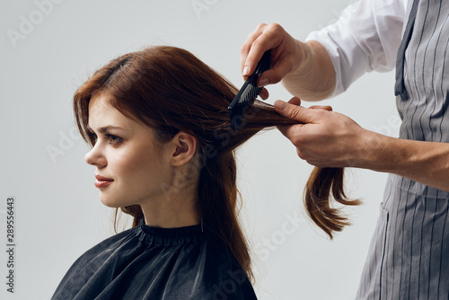 hairdresser cutting hair with scissors