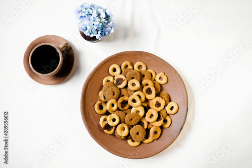 Rosquillas, viejitas and rosquetes on a handmade clay plate with a cup of coffee. No people. 