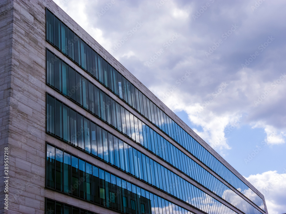 Cloudy sky reflected in the glass wall of a high building Cloudy sky reflected in the glass wall of a high building