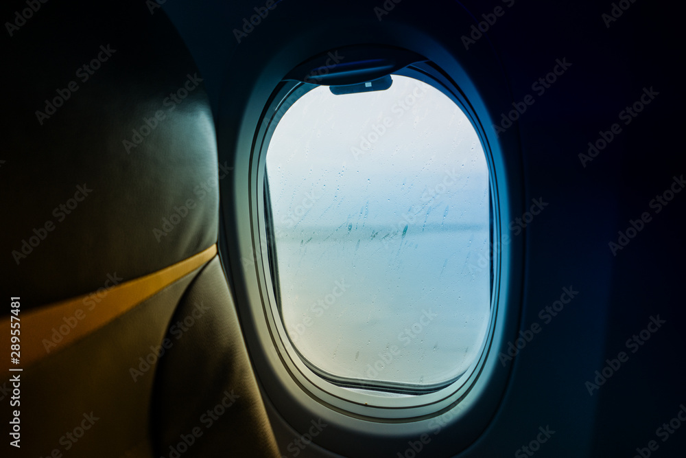 Naklejka premium Raindrops on window glass From Passenger Seat On Airplane