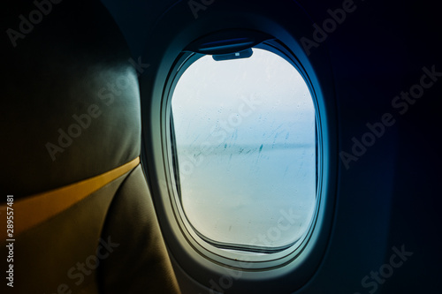 Raindrops on window glass From Passenger Seat On Airplane