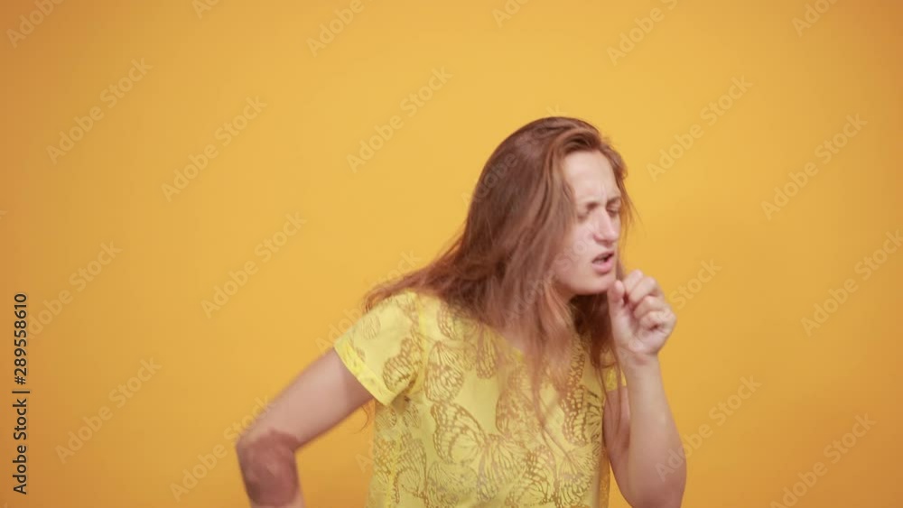 brunette girl in yellow t-shirt over isolated orange background shows emotions brunette girl in yellow t-shirt over isolated orange background shows emotions