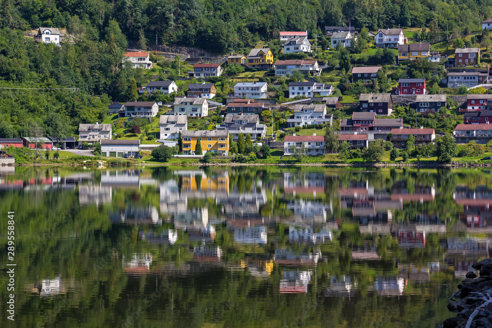 View to the small town Norheimsund. The houses are reflected in the calm water