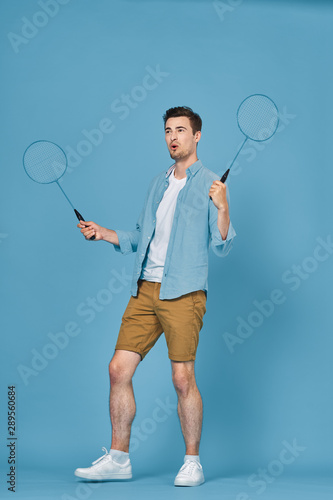 young man with tennis racket and ball