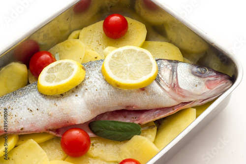 Fish with lemon potatoes and tomatoes ready for the oven
