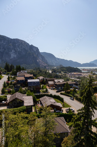 Beautiful view of residential homes in a small town with Chief Mountain in the background during a sunny summer day. Taken in Squamish  North of Vancouver  British Columbia  Canada.