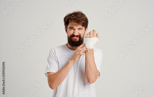 man with bandaged hand isolated on white