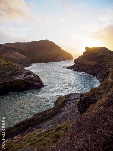 Wide vertical view of River Valency flowing through Boscastle Harbour during sunset. Cornwall, United Kingdom. Travel and nature.