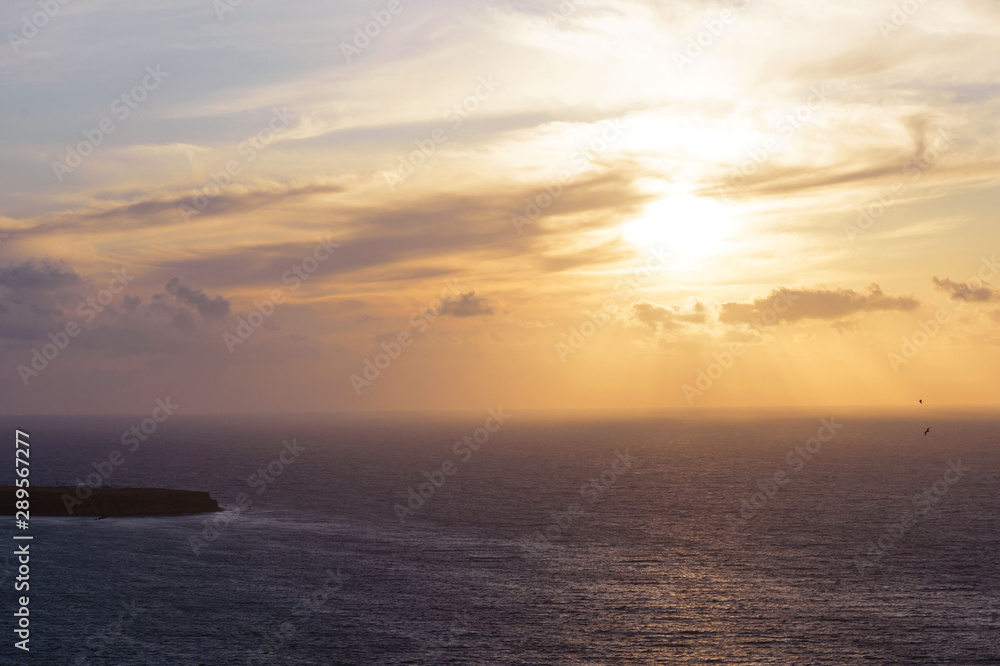 Beautiful sunset at the sea on Santorini island, Greece. Romantic trip.