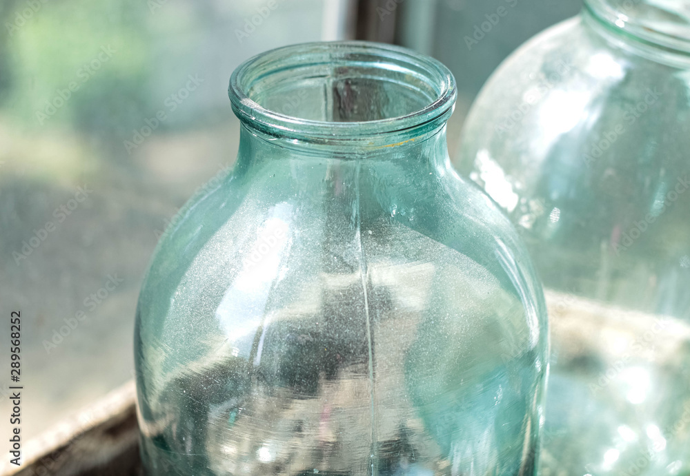 An empty three-liter jar in the dust closeup. Dishes for canning. An empty three-liter jar in the dust closeup. Dishes for canning.