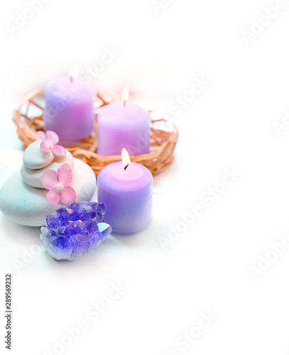 amethyst geode crystal  candles  flowers hydrangea  spa stones on white background. Spa therapy composition. Ritual for relaxation  meditation. Gentle spa and wellness background. soft selective focus