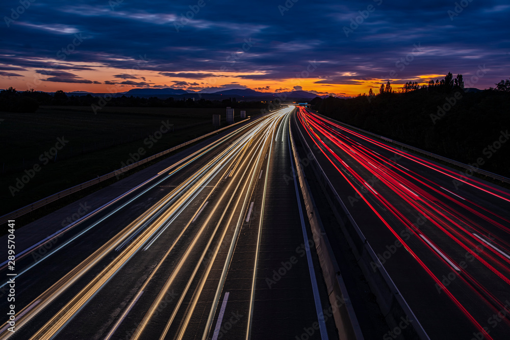 busy traffic on highway at sunset time busy traffic on highway at sunset time