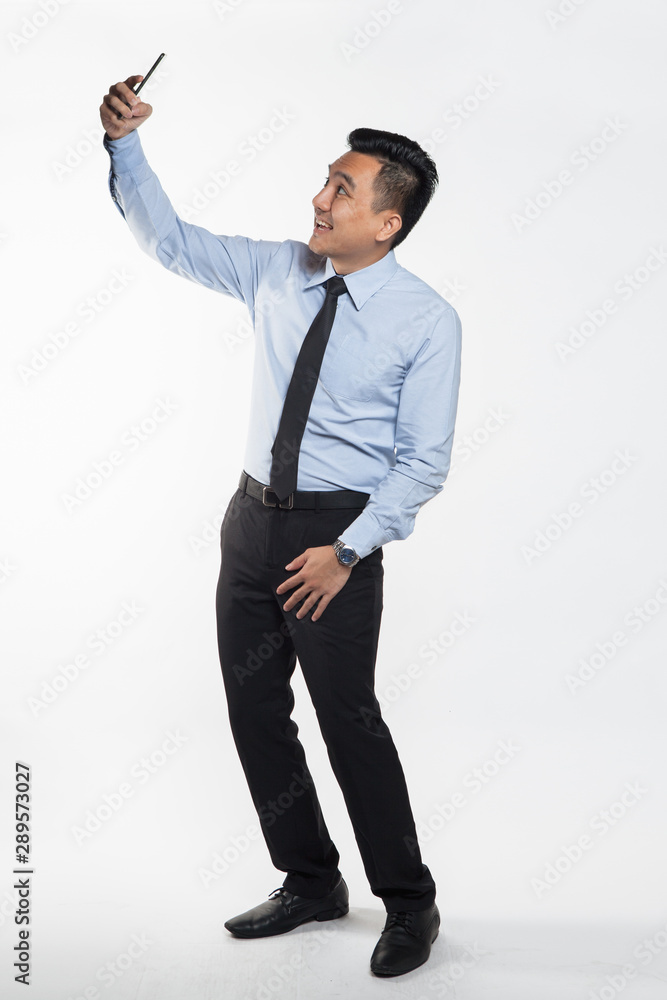 Man in business attire taking selfie. Man in business attire taking selfie.