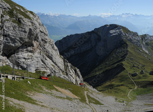 One of Switzerland main tourist attraction: Travelling with the world strongest rise cog railway with up to 48% grade driving up mount Pilatus at Lake Lucerne