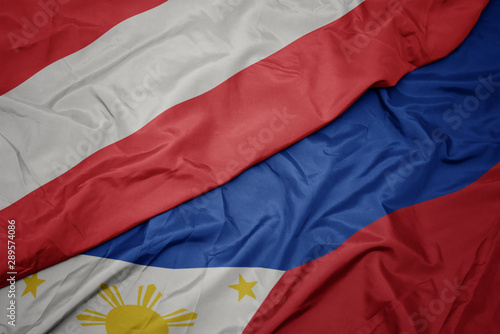 waving colorful flag of philippines and national flag of austria.