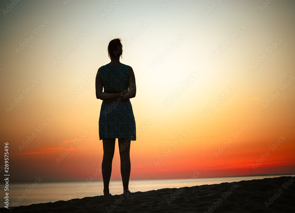 woman posing at sea sunset