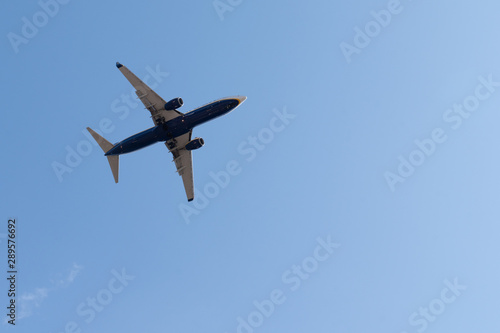 Airplane flying in the blue sky with copy space