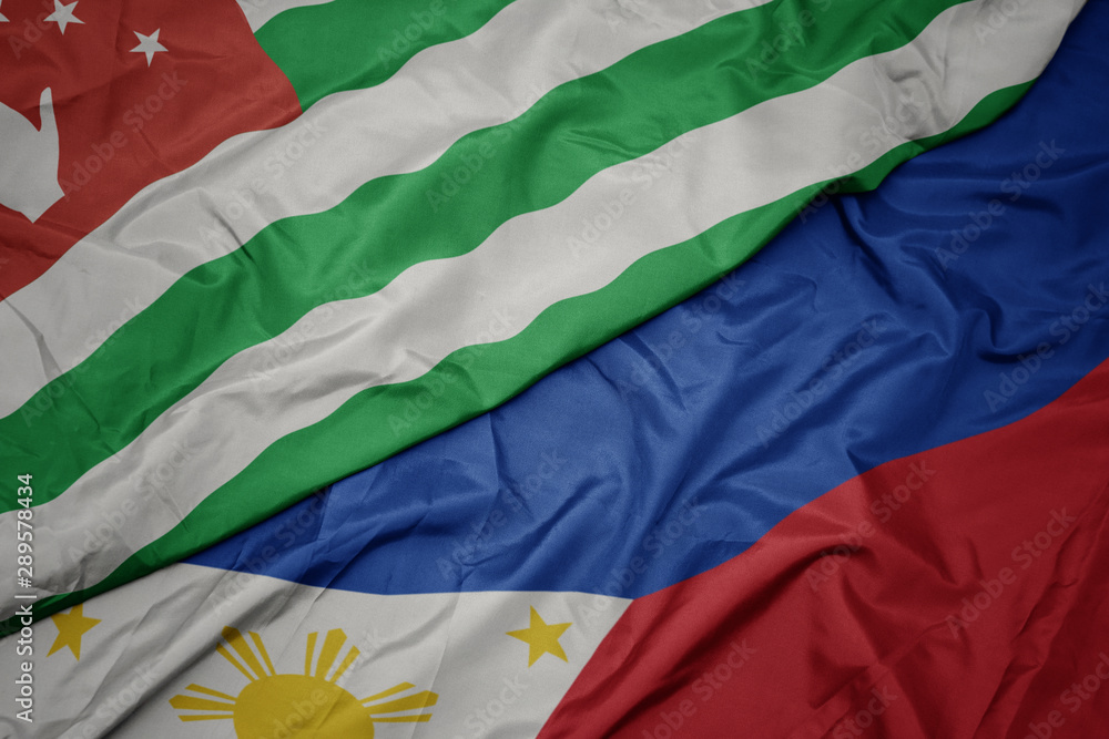 waving colorful flag of philippines and national flag of abkhazia. waving colorful flag of philippines and national flag of abkhazia.