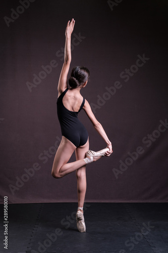 Ballerina on pointe in a black swimsuit