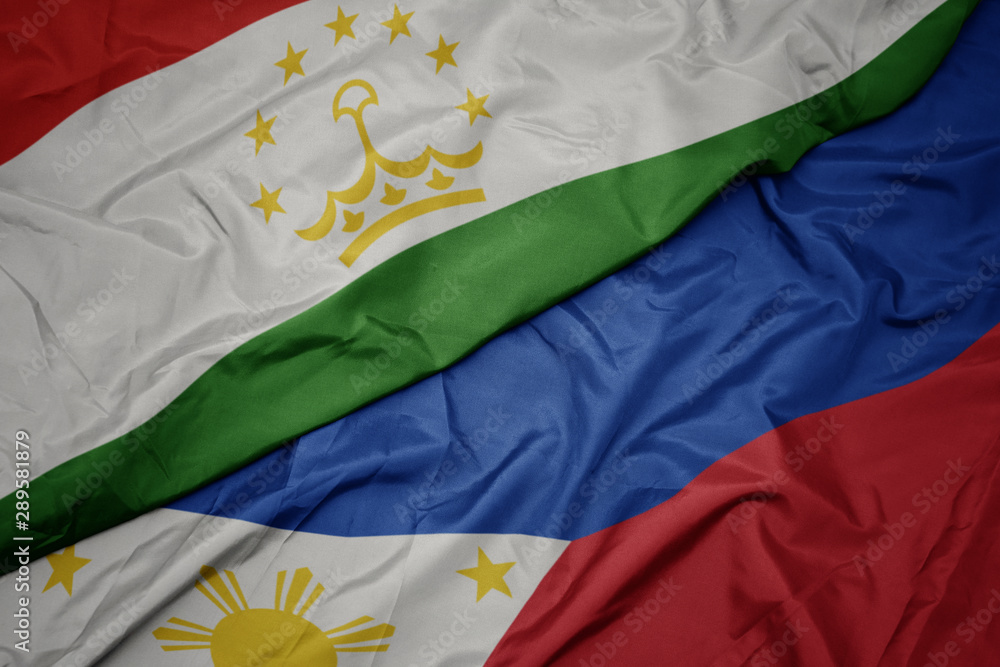 waving colorful flag of philippines and national flag of tajikistan. waving colorful flag of philippines and national flag of tajikistan.