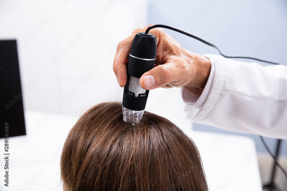 Fototapeta premium Dermatologist Using Trichoscope For Hair Fall Treatment