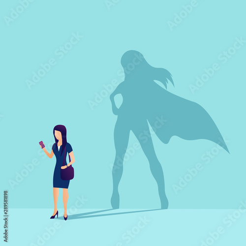 Vector of a businesswoman with superhero shadow. Symbol of ambition motivation leadership and challenge. Flat style. Vector illustration. EPS 10