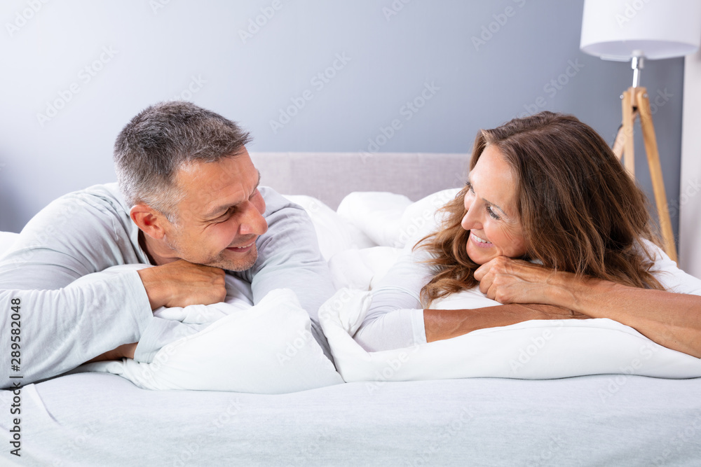 Couple Relaxing On Bed Couple Relaxing On Bed