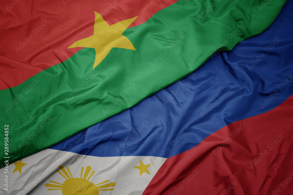 waving colorful flag of philippines and national flag of burkina faso. waving colorful flag of philippines and national flag of burkina faso.