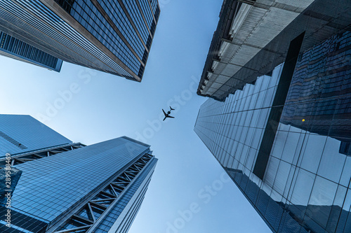 Plane Flying Above New York Buildings photo