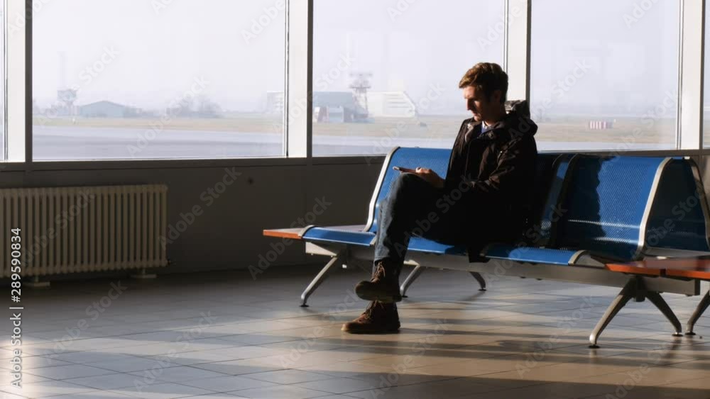 Passenger Waiting at Airport and Using Mobile Phone Passenger Waiting at Airport and Using Mobile Phone