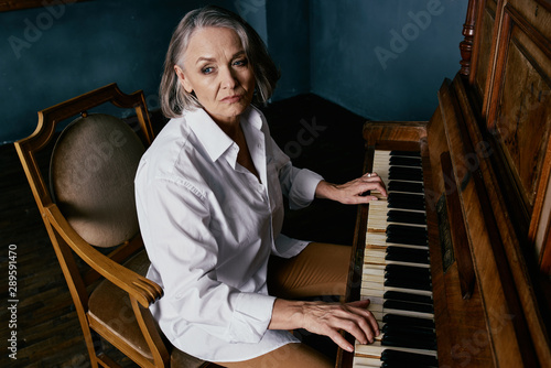 young woman playing piano photo