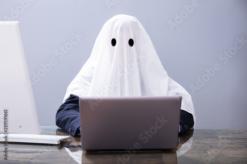 Ghostwriter Writing Article On Laptop photo