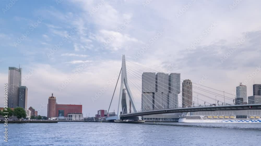 Zooming out camera of ships floating Maas river in Rotterdam, Netherlands. Amazing dutch cityscape with modern european city center with Erasmus Bridge (Erasmusbrug) and skyscrapers. Time lapse Zooming out camera of ships floating Maas river in Rotterdam, Netherlands. Amazing dutch cityscape with modern european city center with Erasmus Bridge (Erasmusbrug) and skyscrapers. Time lapse