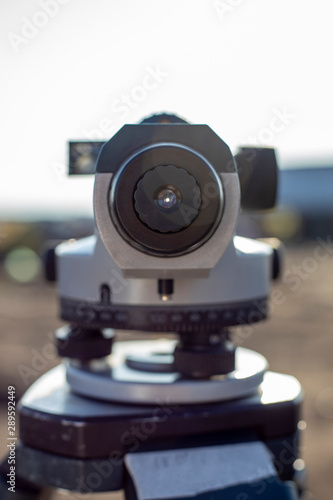 Close up of the lens of geodetic optical level in the field
