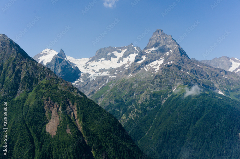 Fototapeta premium Northern great caucasus mountains near dombay with glaciers and snow in august 2019, original raw picture