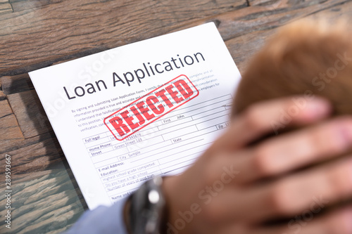 Person Looking At Rejected Loan Application